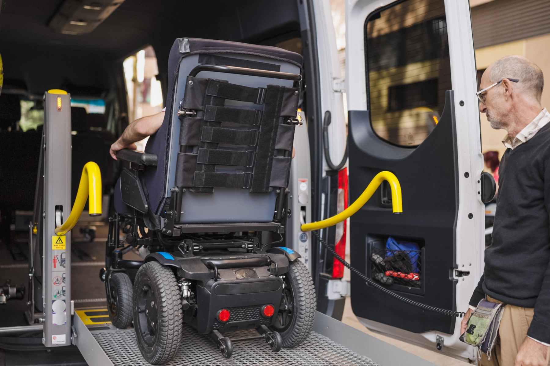 Disability accessible transport van assisting wheelchair user