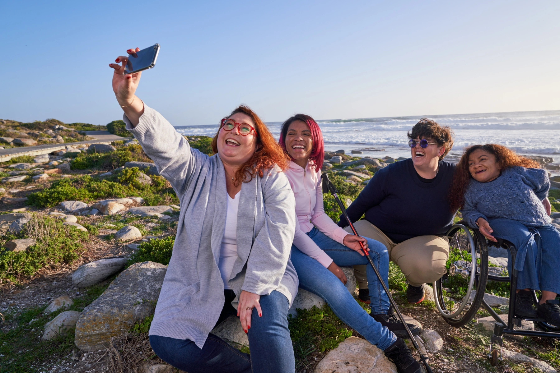 Diverse group of friends taking a selfie at the beach